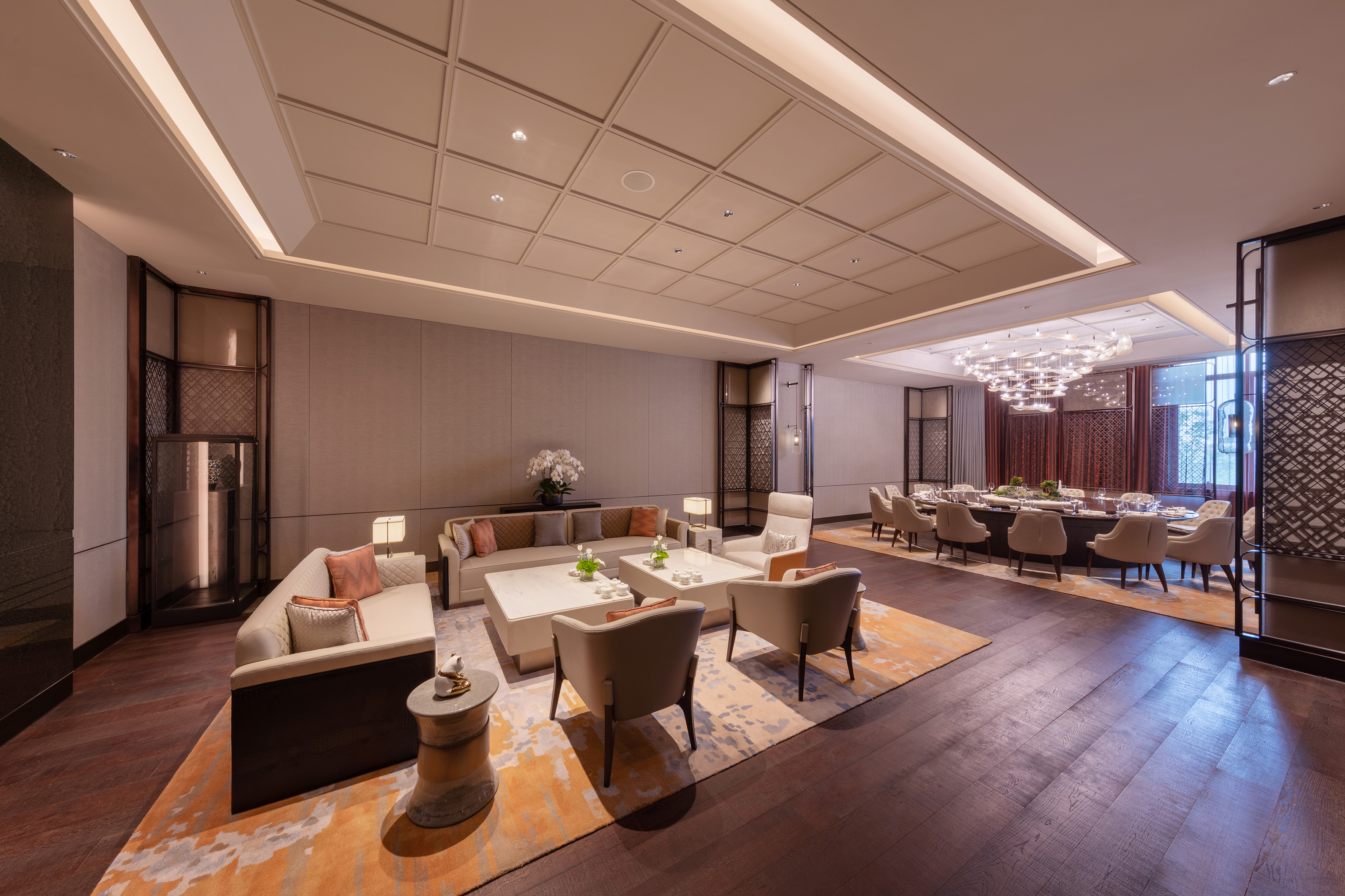 Luxurious hotel lounge with modern seating and an elegant private dining area.