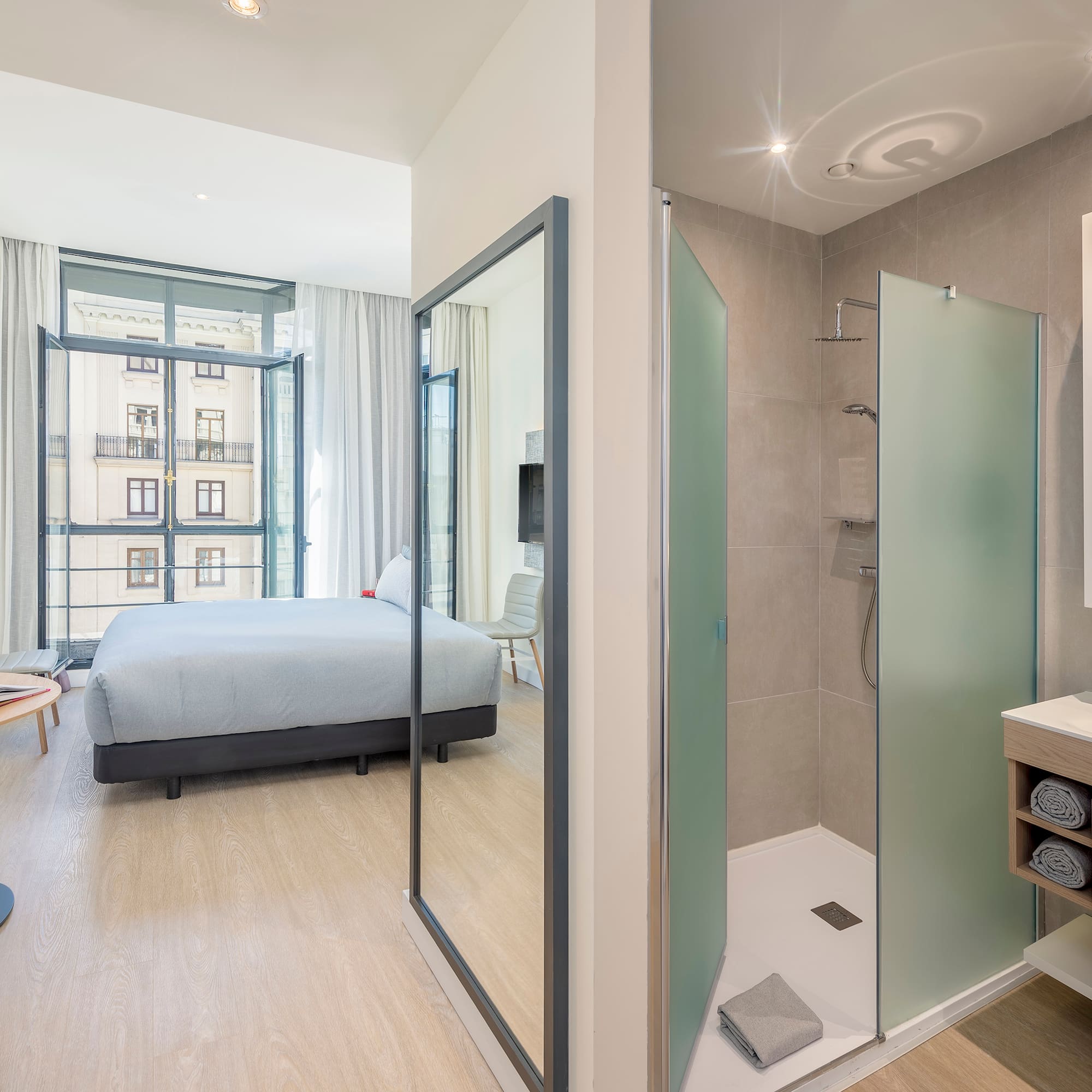 a bathroom with a bed and shower