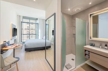 a bathroom with a bed and shower