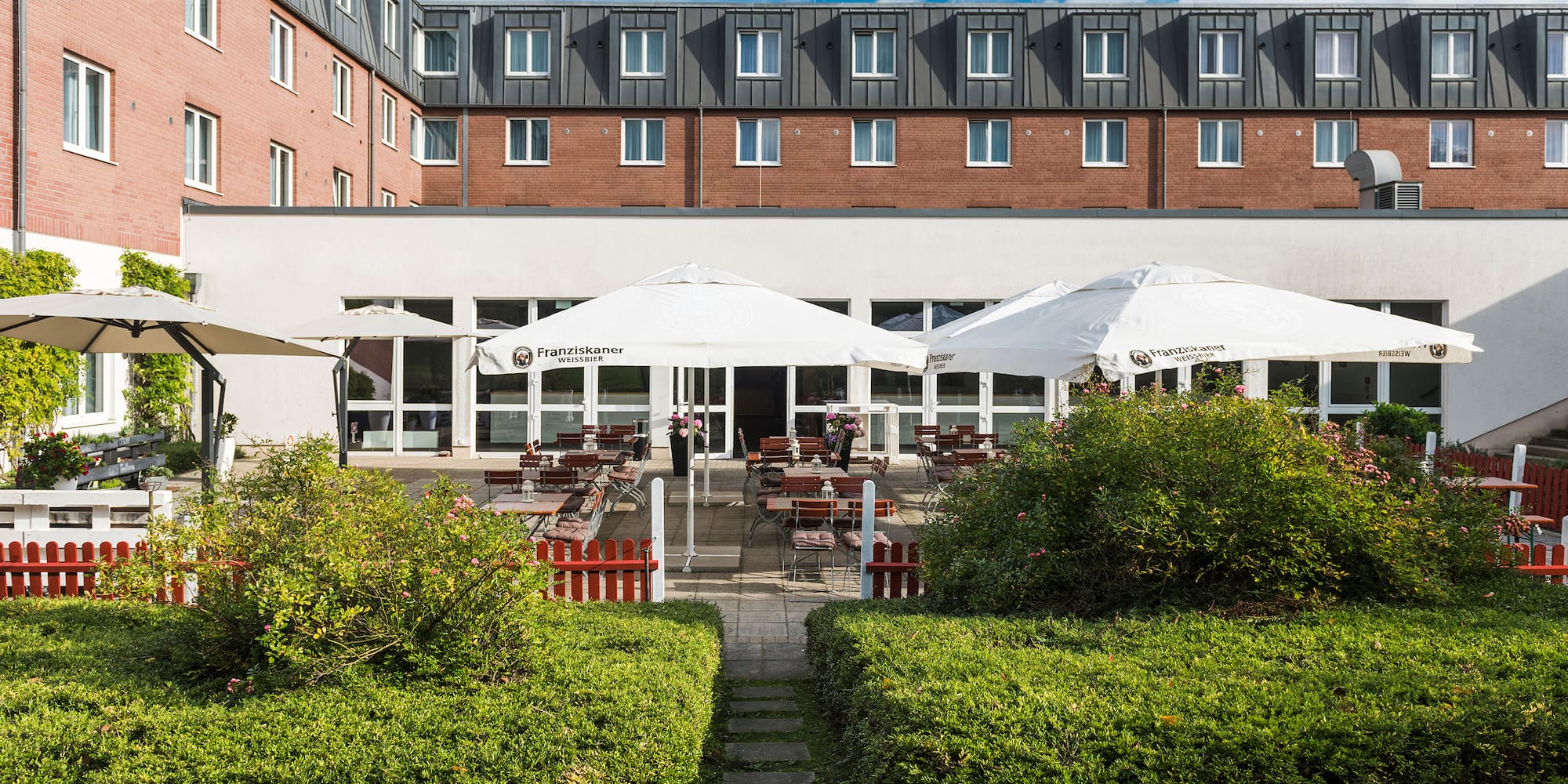 a building with a patio and umbrellas