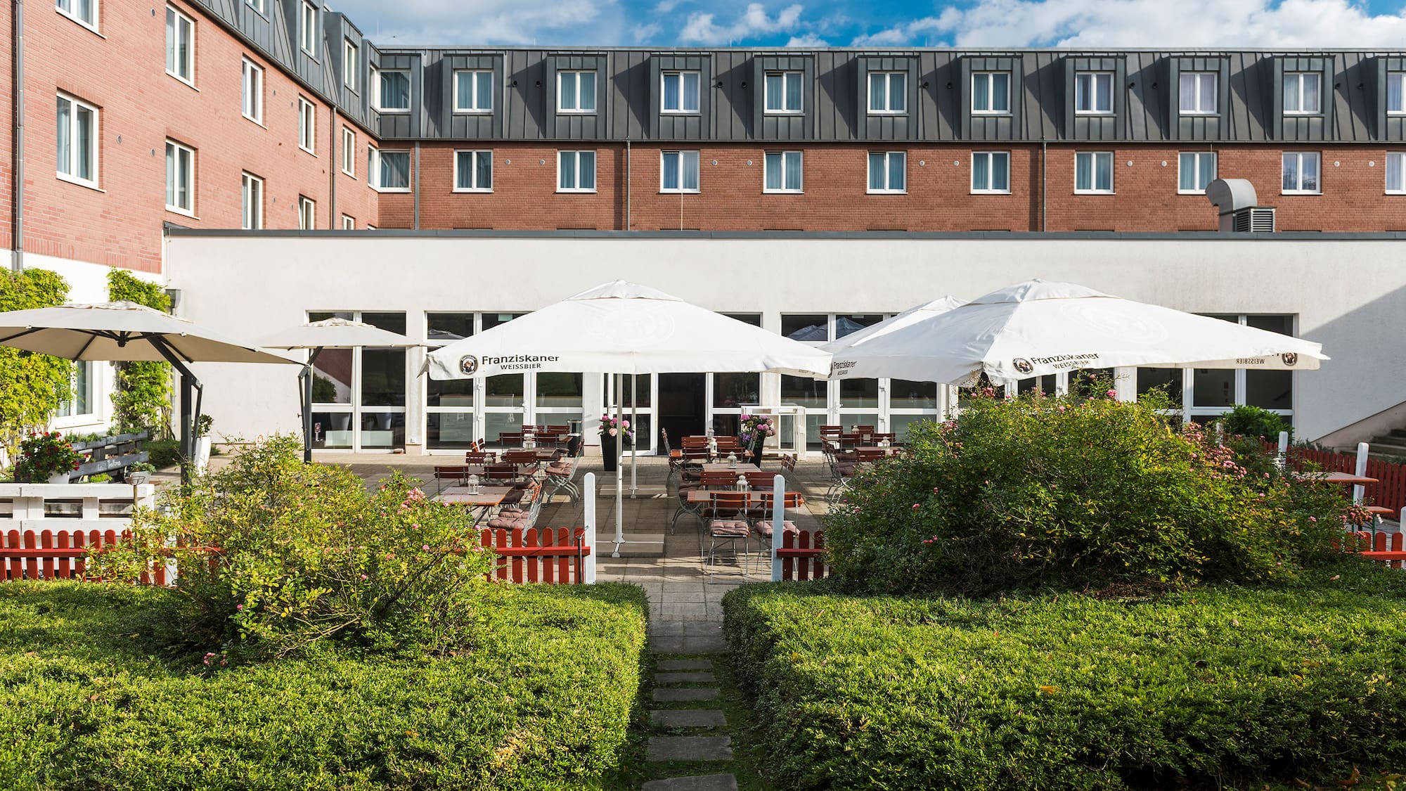 a building with a patio and umbrellas