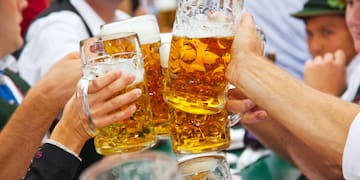 a group of people clinking glasses of beer