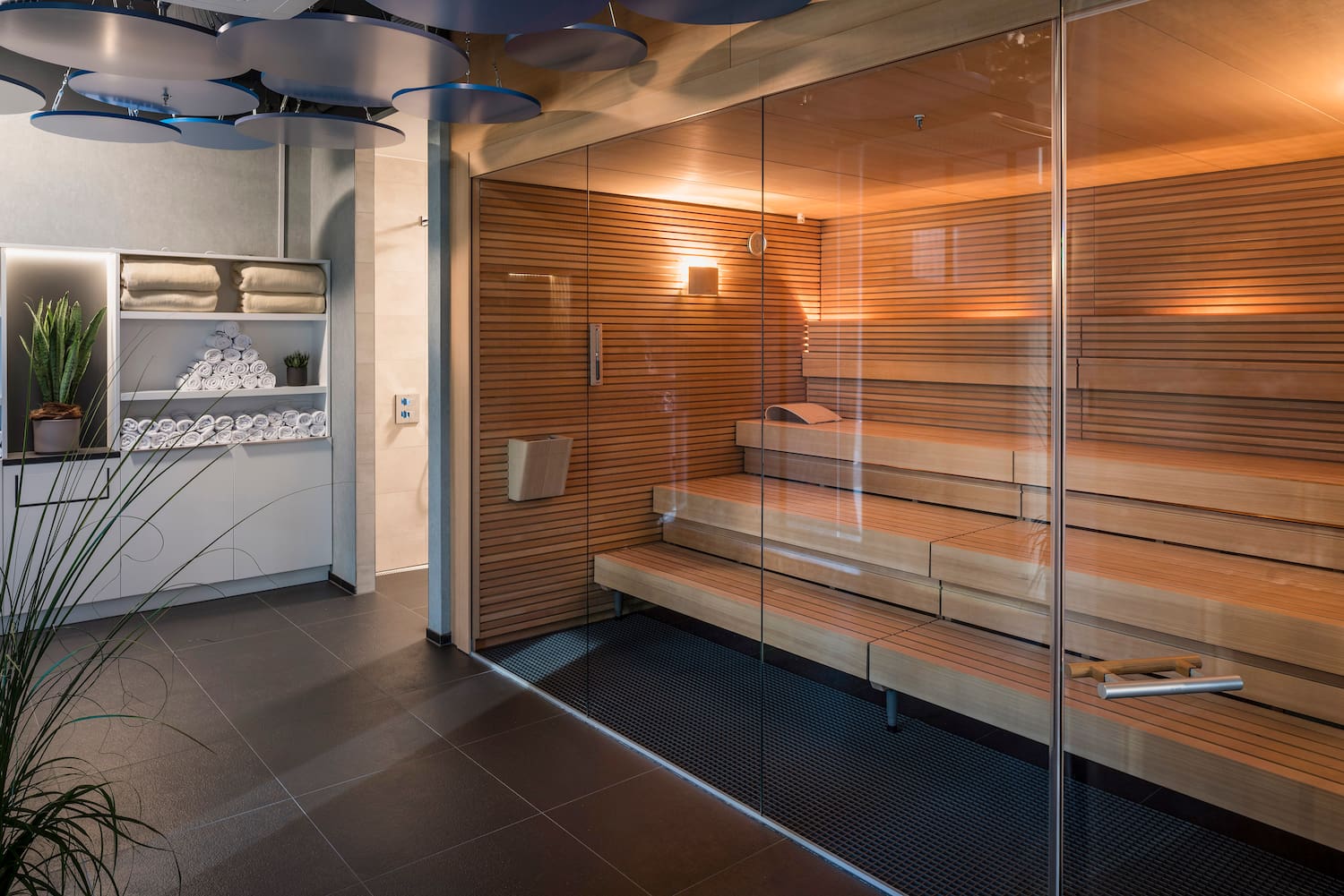 a sauna with glass walls and a glass door