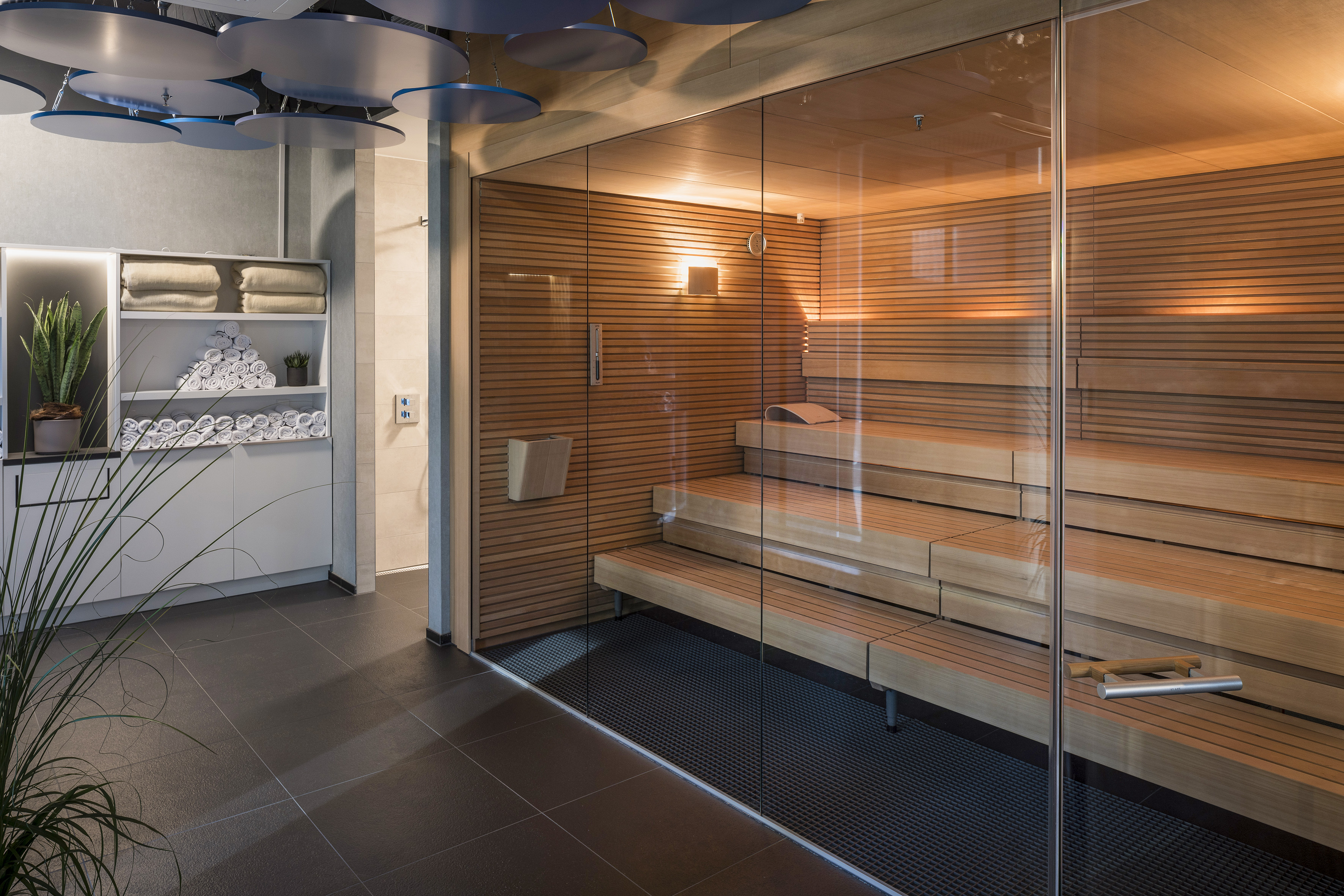 a sauna with glass walls and a glass door