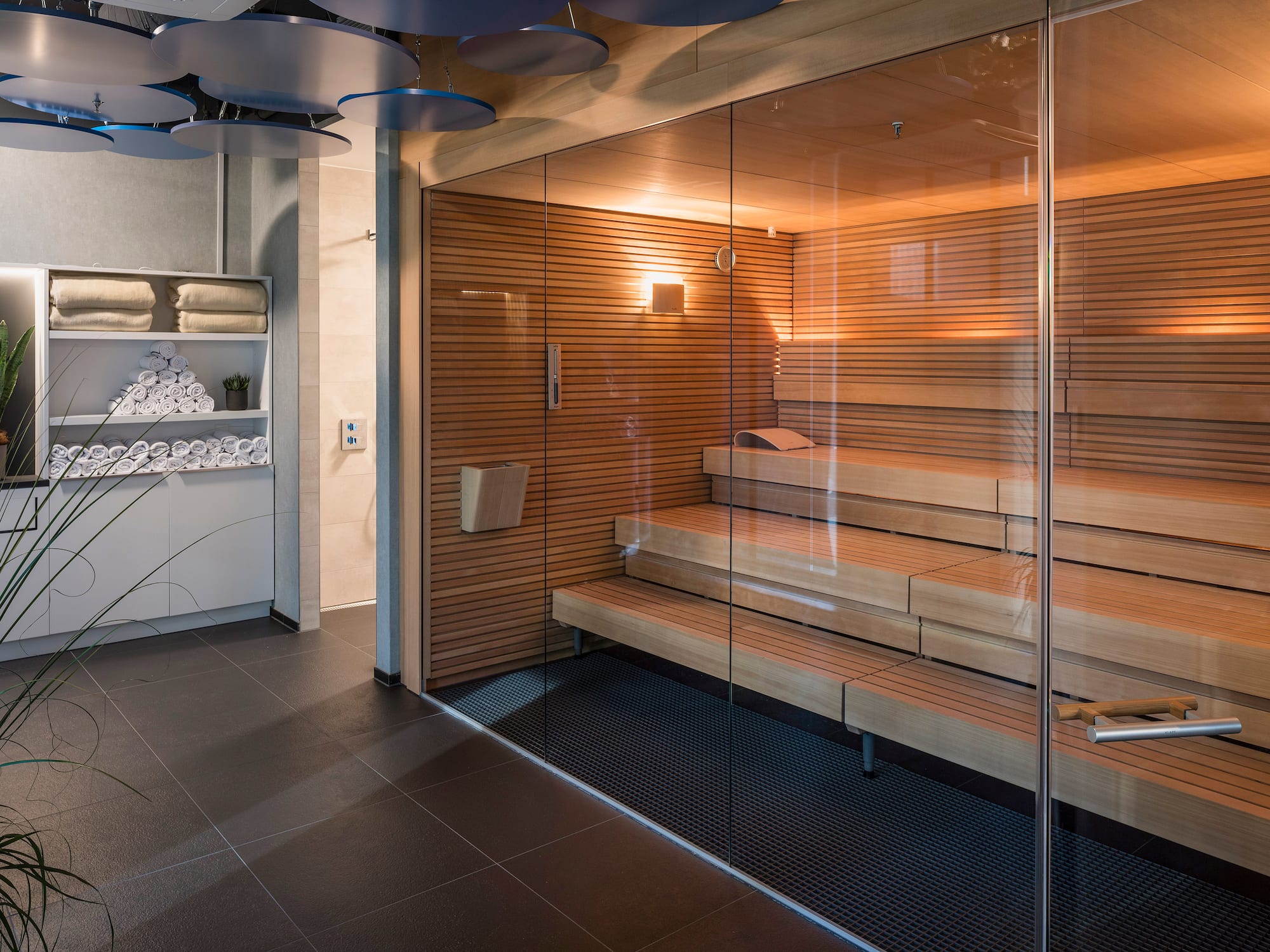 a sauna with glass walls and a glass door