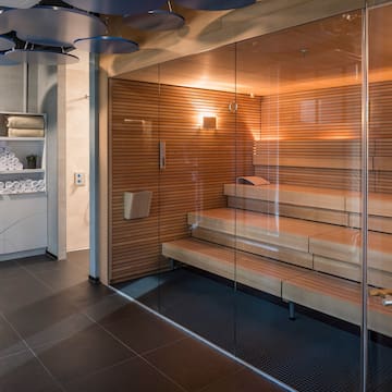 a sauna with glass walls and a glass door