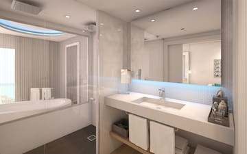 a bathroom with a glass shower and a sink