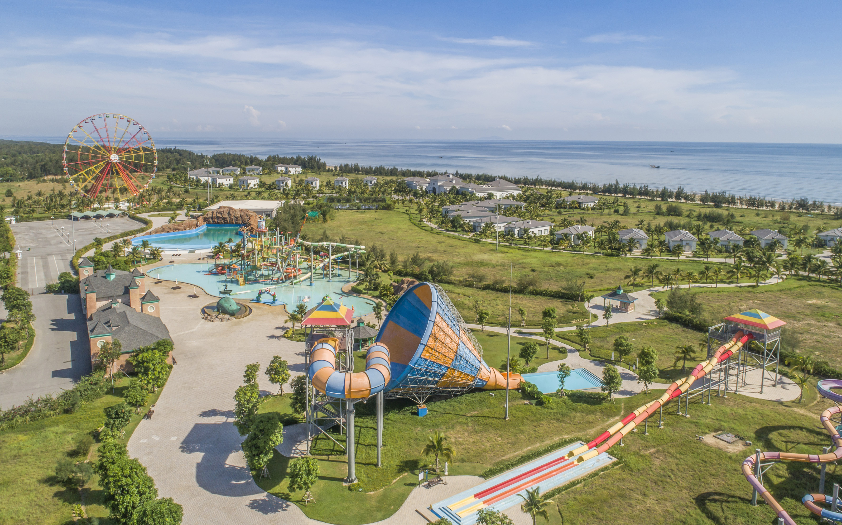an amusement park with a water slide and a beach