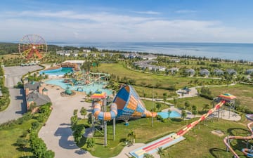 an amusement park with a water slide and a beach