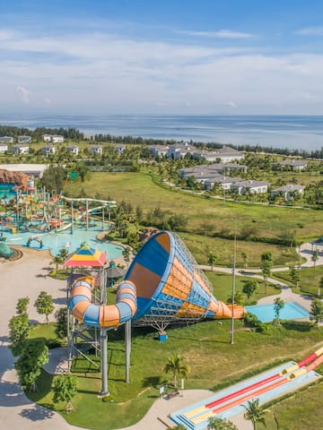 an amusement park with a water slide and a beach