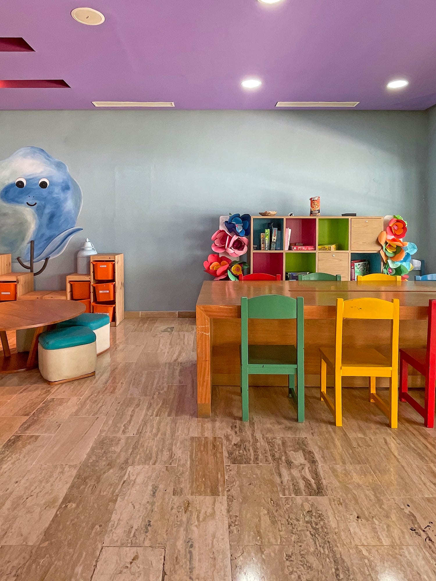 a room with colorful chairs and tables