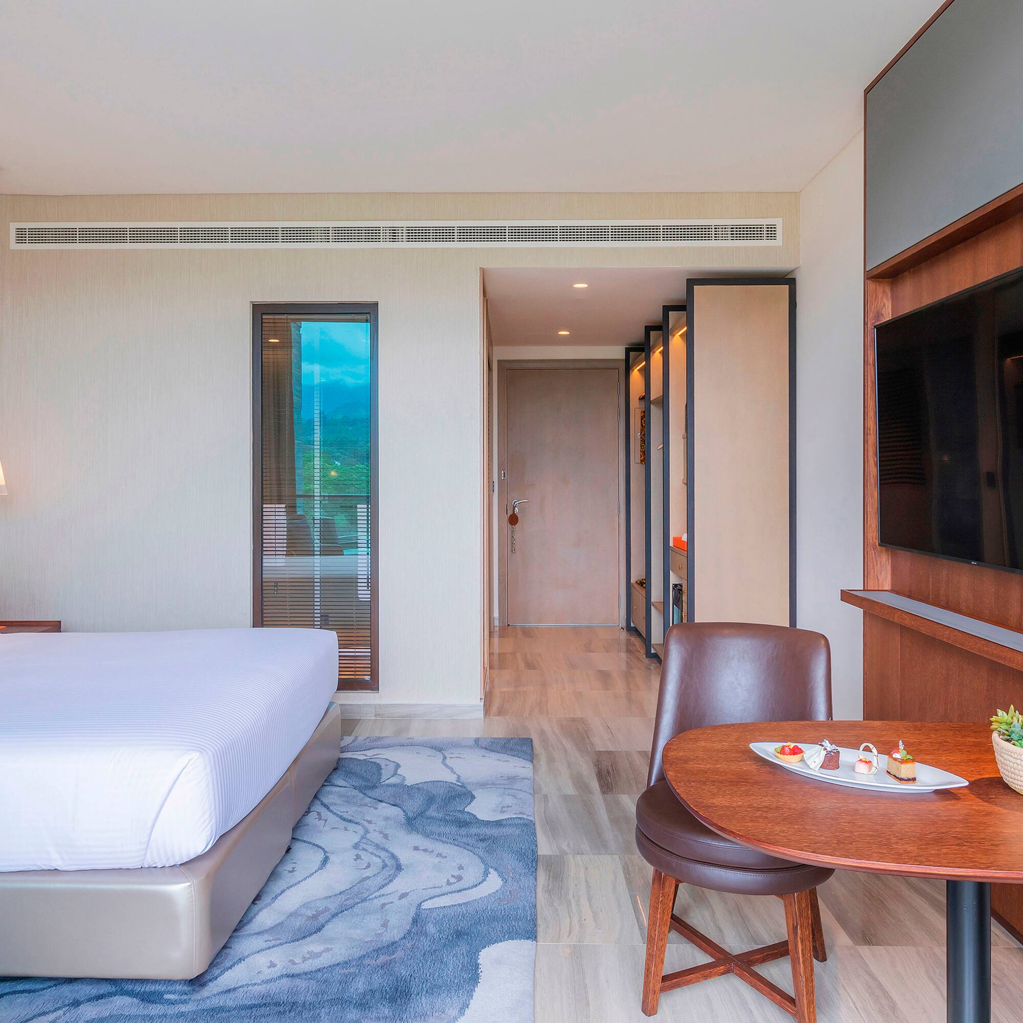 a room with a bed and a tv