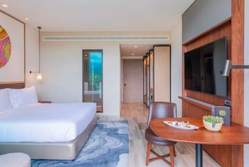 a room with a bed and a tv