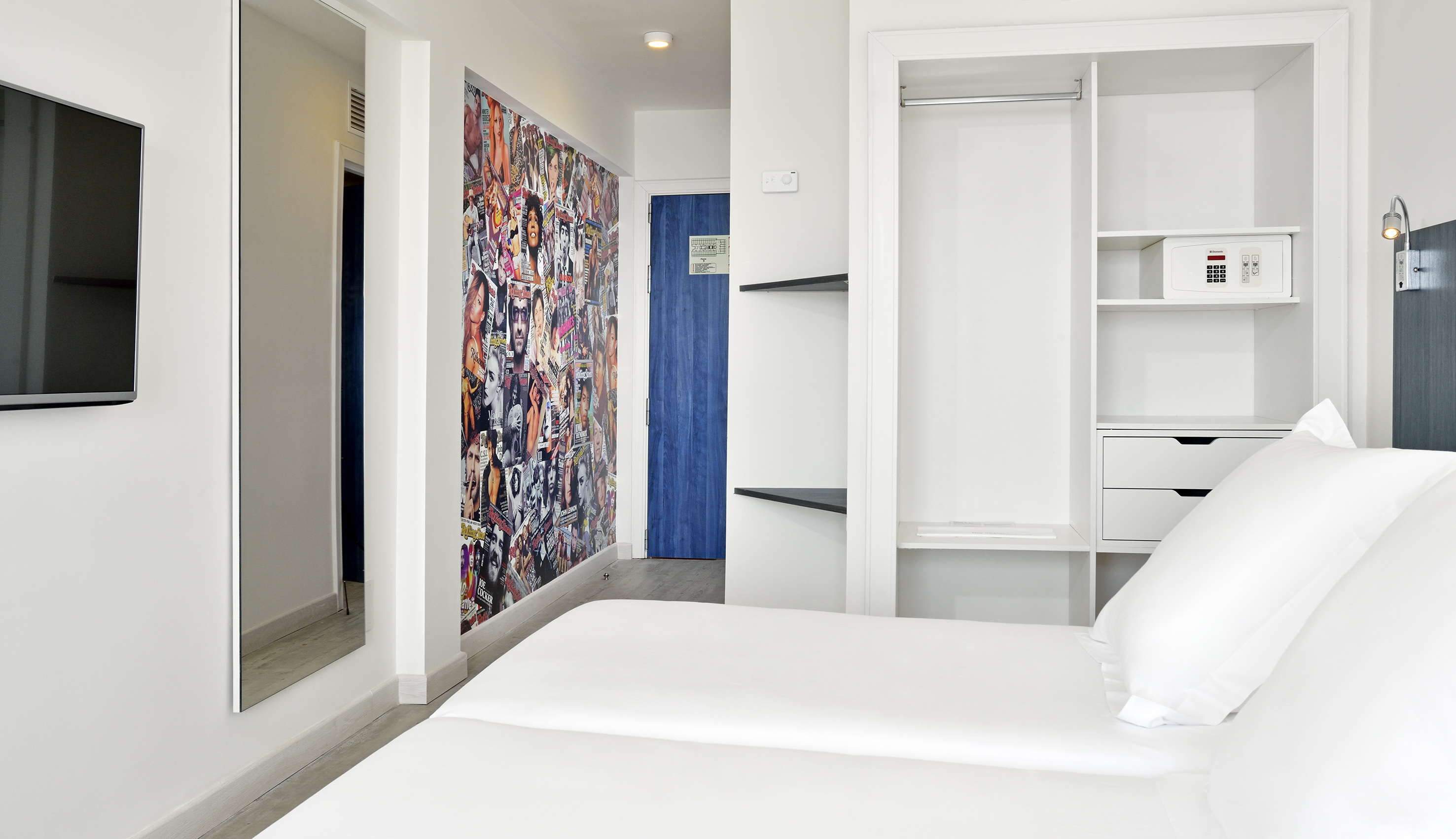 a room with a bed and a mirror