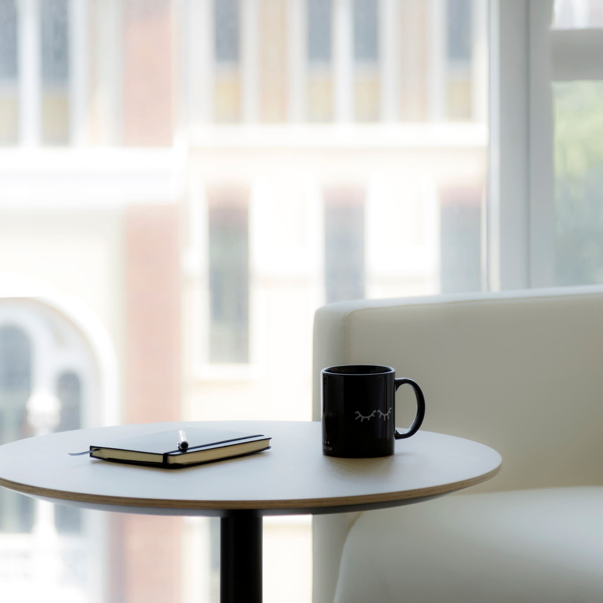 a coffee mug and notepad on a table