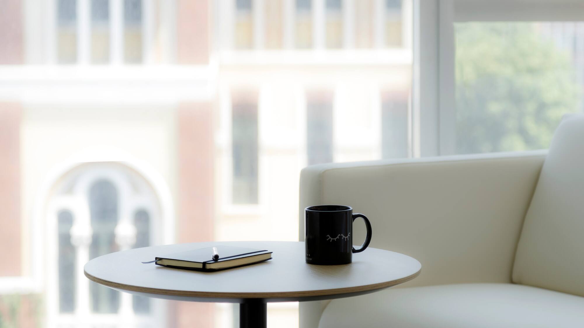 a coffee mug and notepad on a table