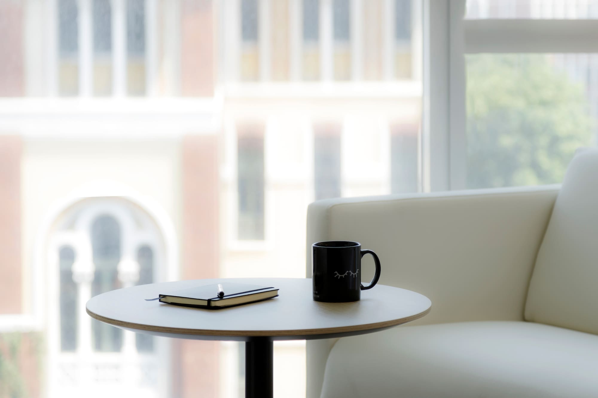a coffee mug and notepad on a table