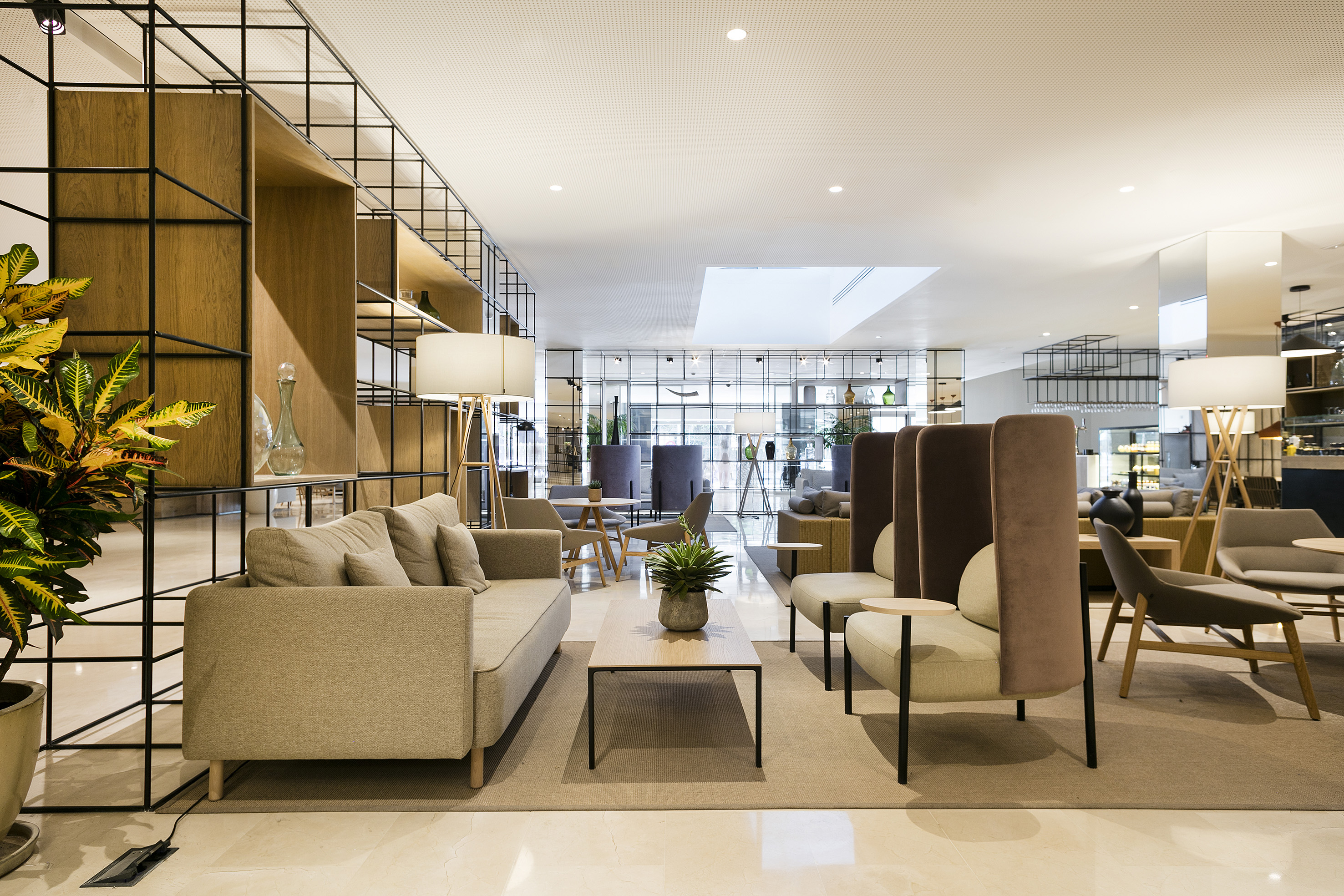 Contemporary hotel lounge with comfortable sofas, stylish decor, wood accents.