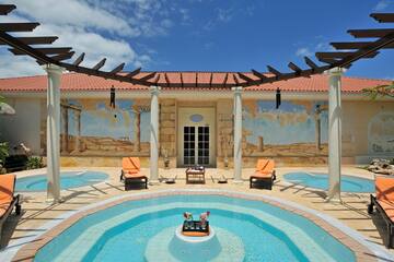 a pool with chairs and a table in the middle