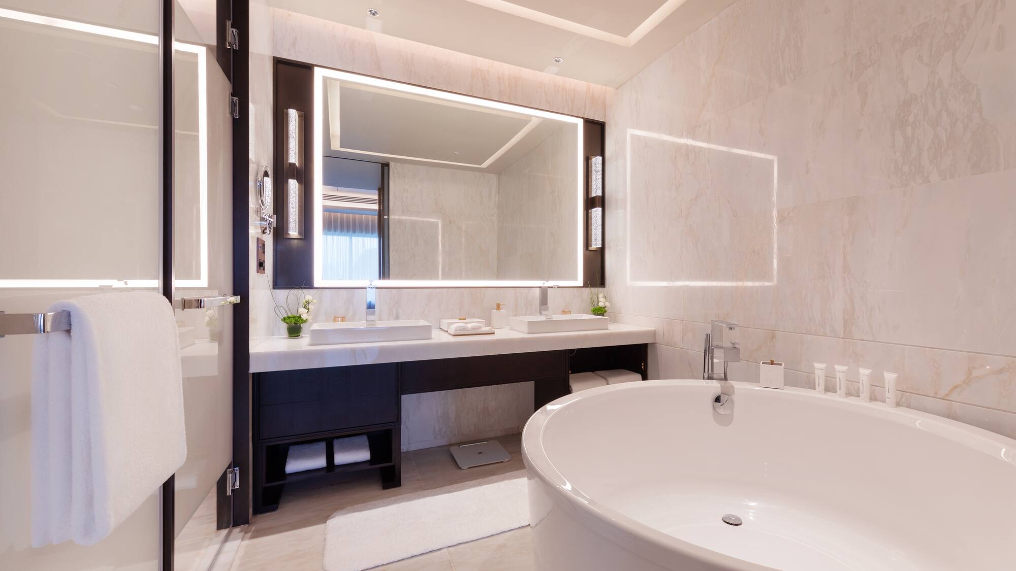 a bathroom with a large tub and a mirror