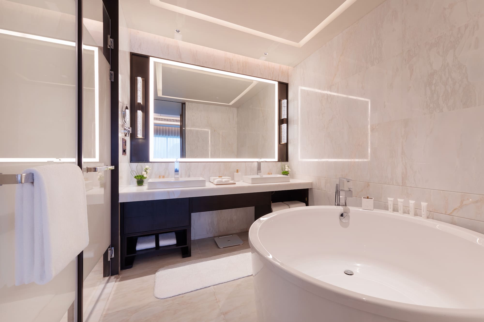 a bathroom with a large tub and a mirror
