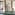 Luxury spa indoor pool with waterfall, palm plants, and woman in bathrobe.