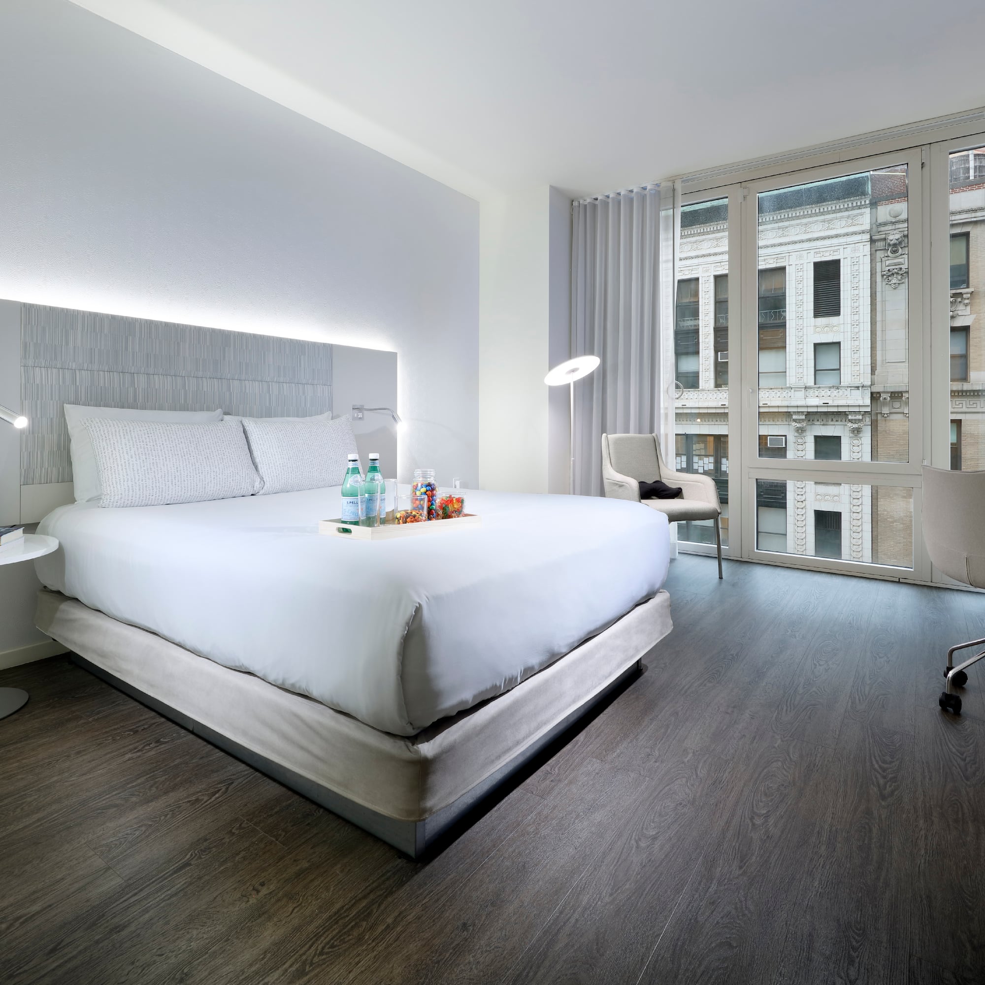 a hotel room with a bed and a chair