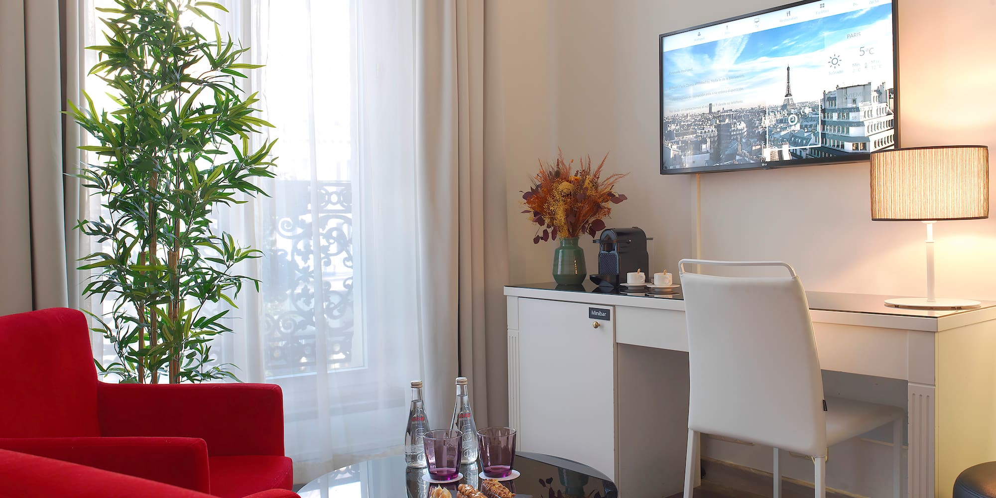 a room with red chairs and a tv