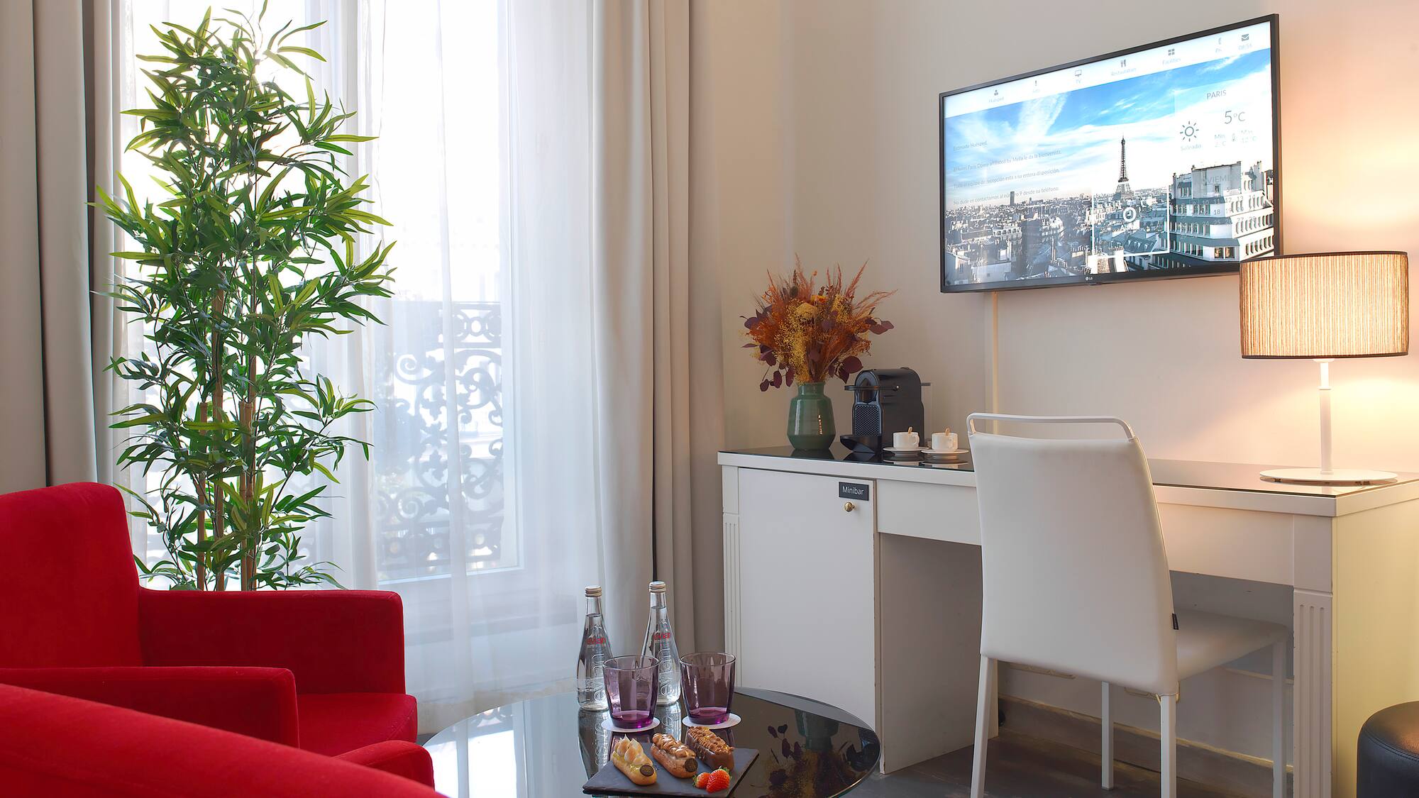 a room with red chairs and a tv