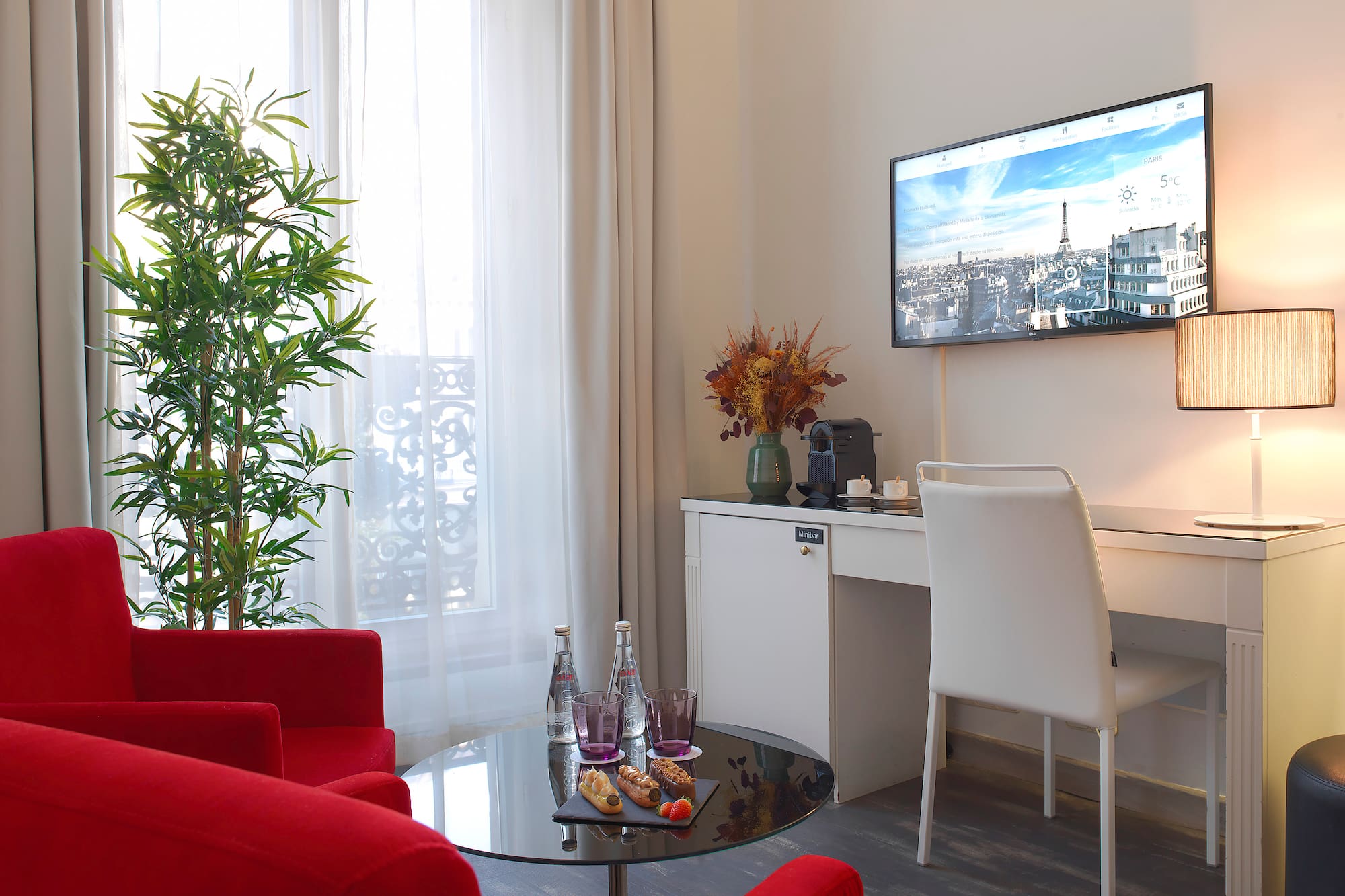 a room with red chairs and a tv