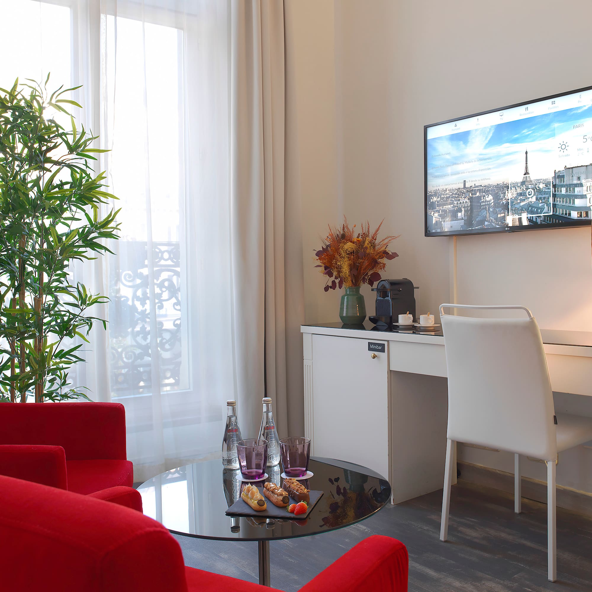 a room with red chairs and a tv