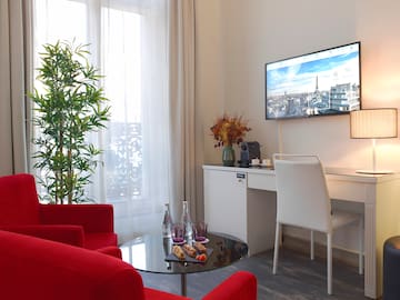 a room with red chairs and a tv