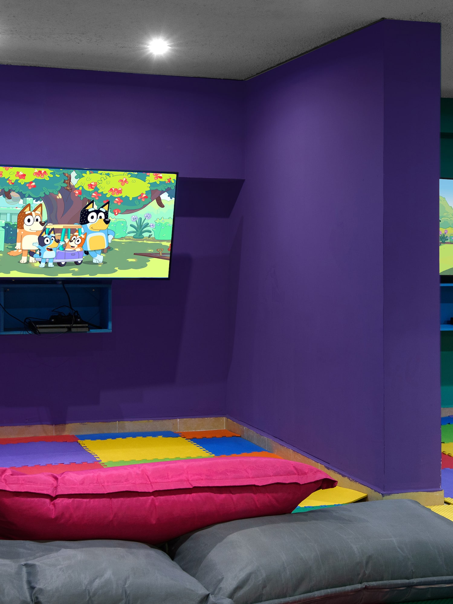 a room with purple walls and colorful pillows