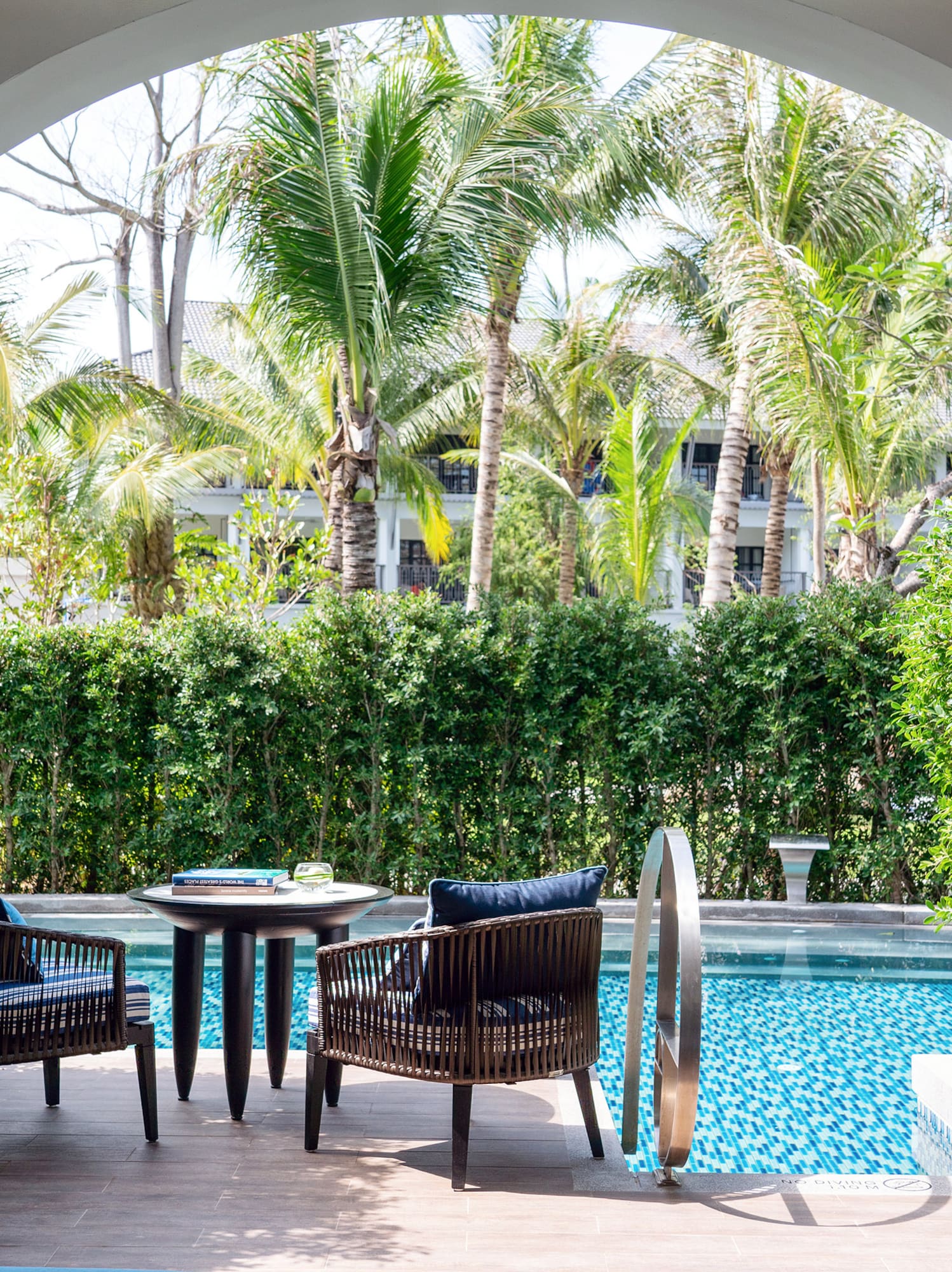 a pool with chairs and tables
