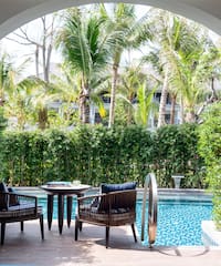 a pool with chairs and tables