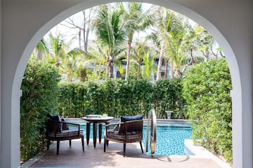 a pool with chairs and tables