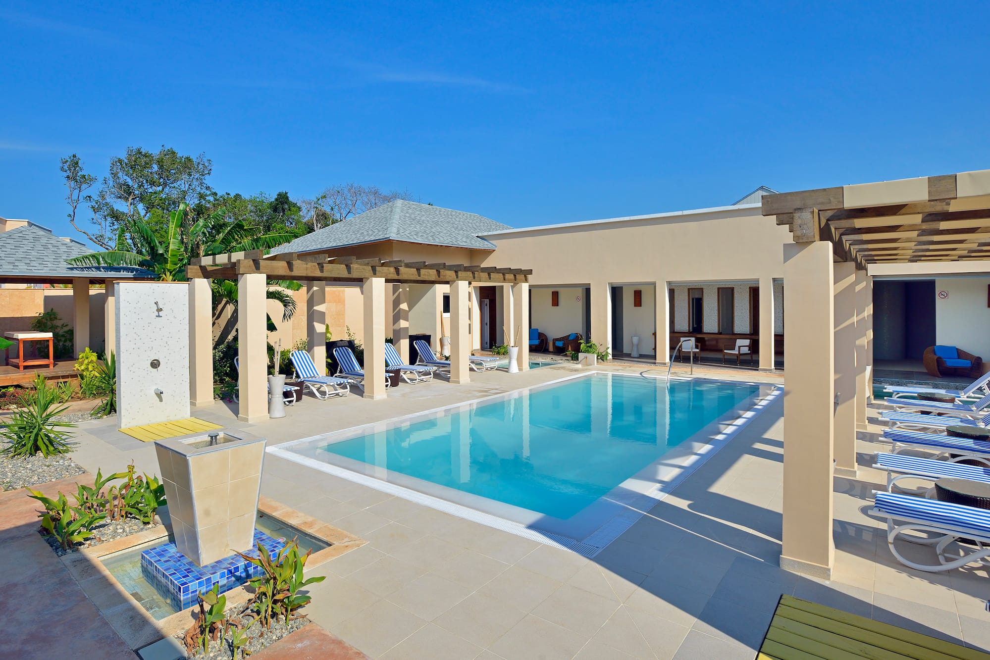 a pool with a gazebo and a fountain