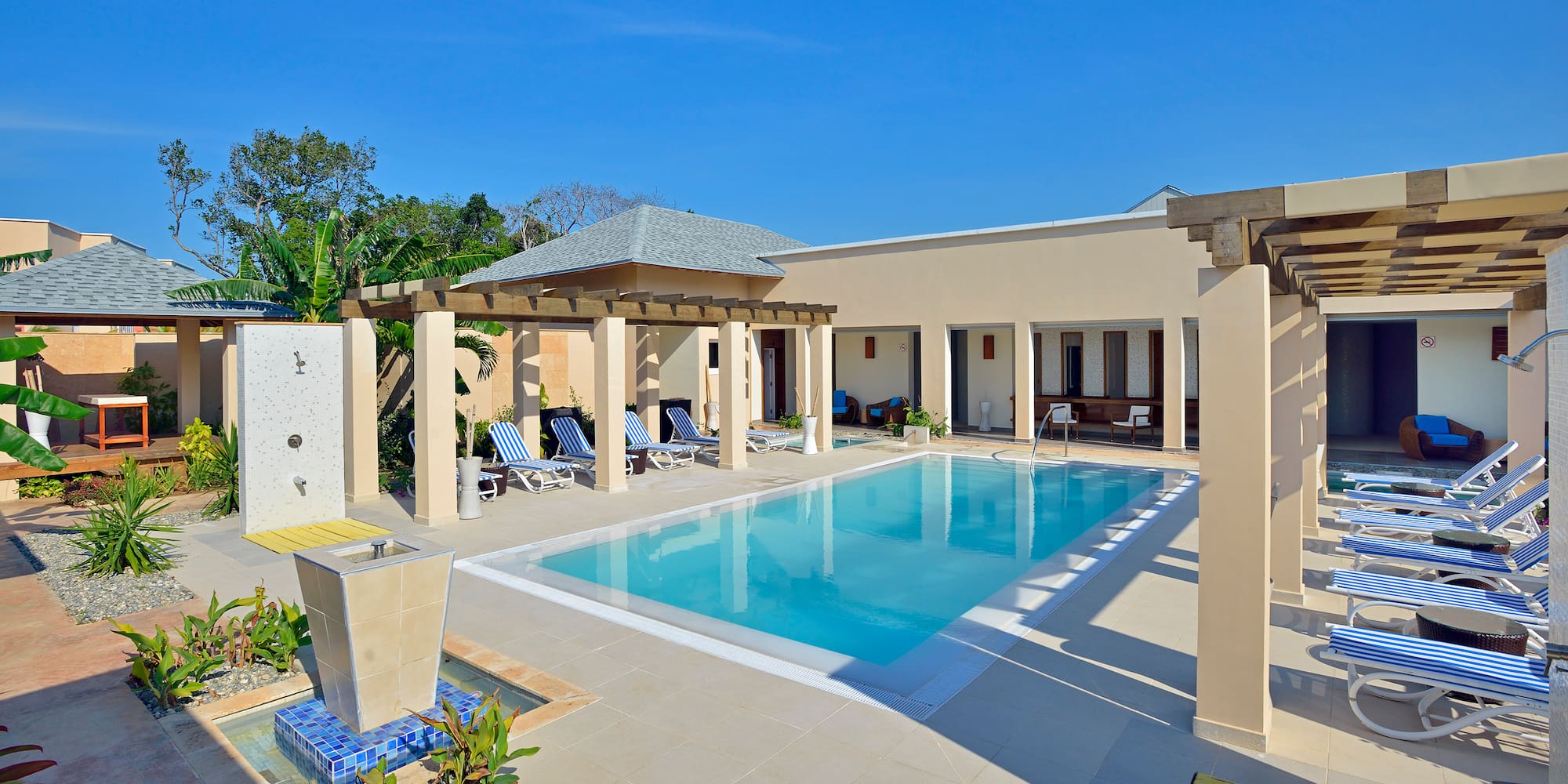 a pool with a gazebo and a fountain