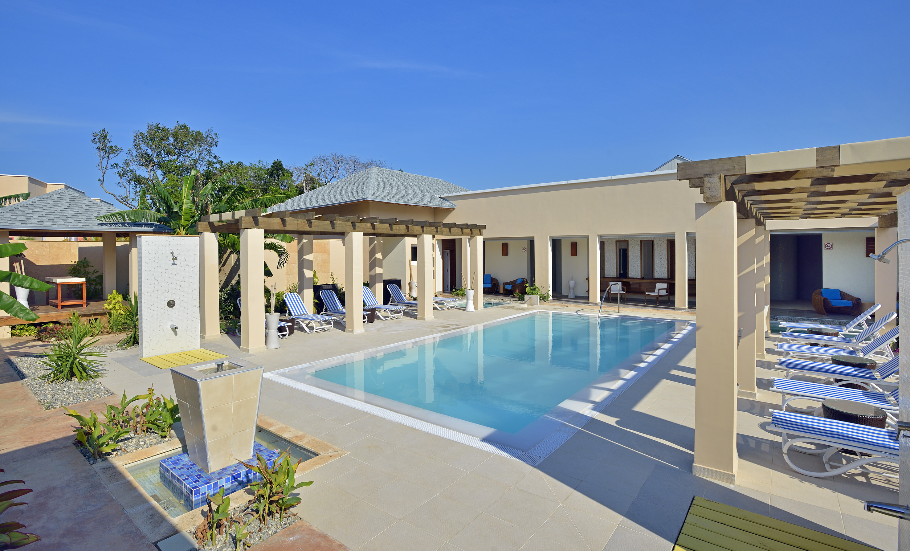 a pool with a gazebo and a fountain
