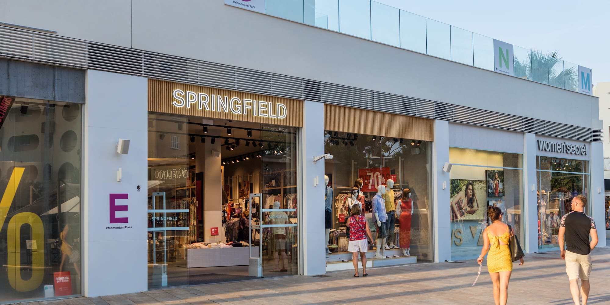 a storefront with people walking in front of it