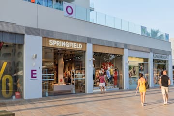 a storefront with people walking in front of it
