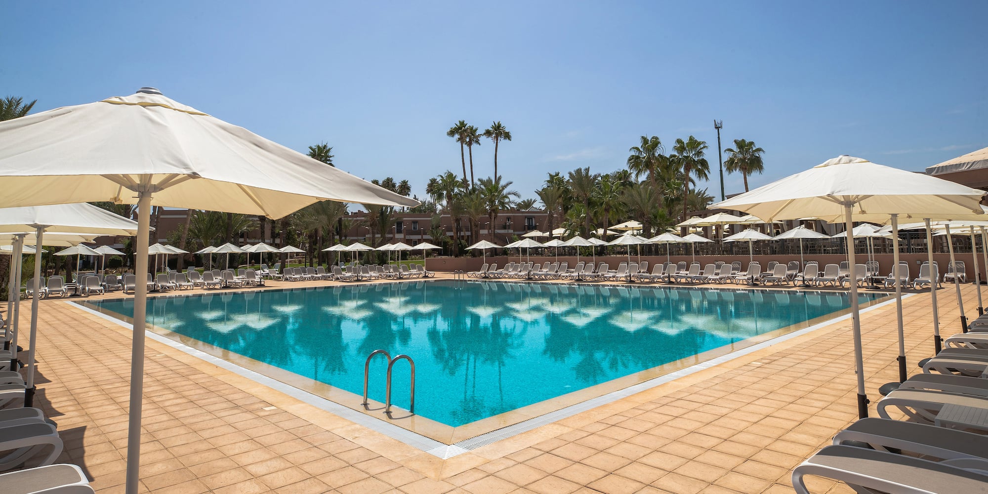 a pool with umbrellas and chairs