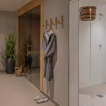 a bathroom with a bathrobe and a shower