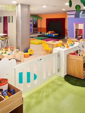 a room with a playroom and a play area
