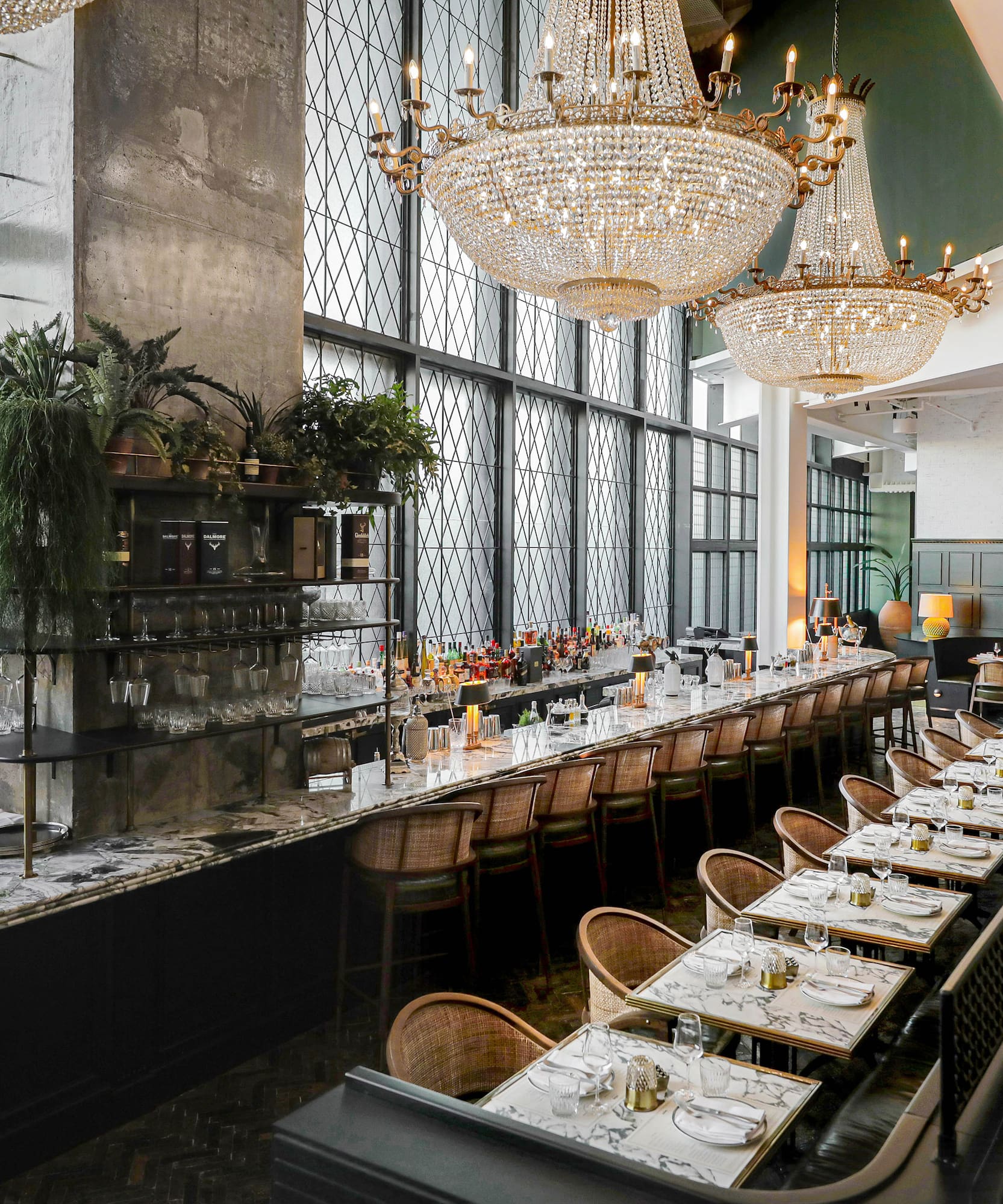 a long table with chairs and chandeliers
