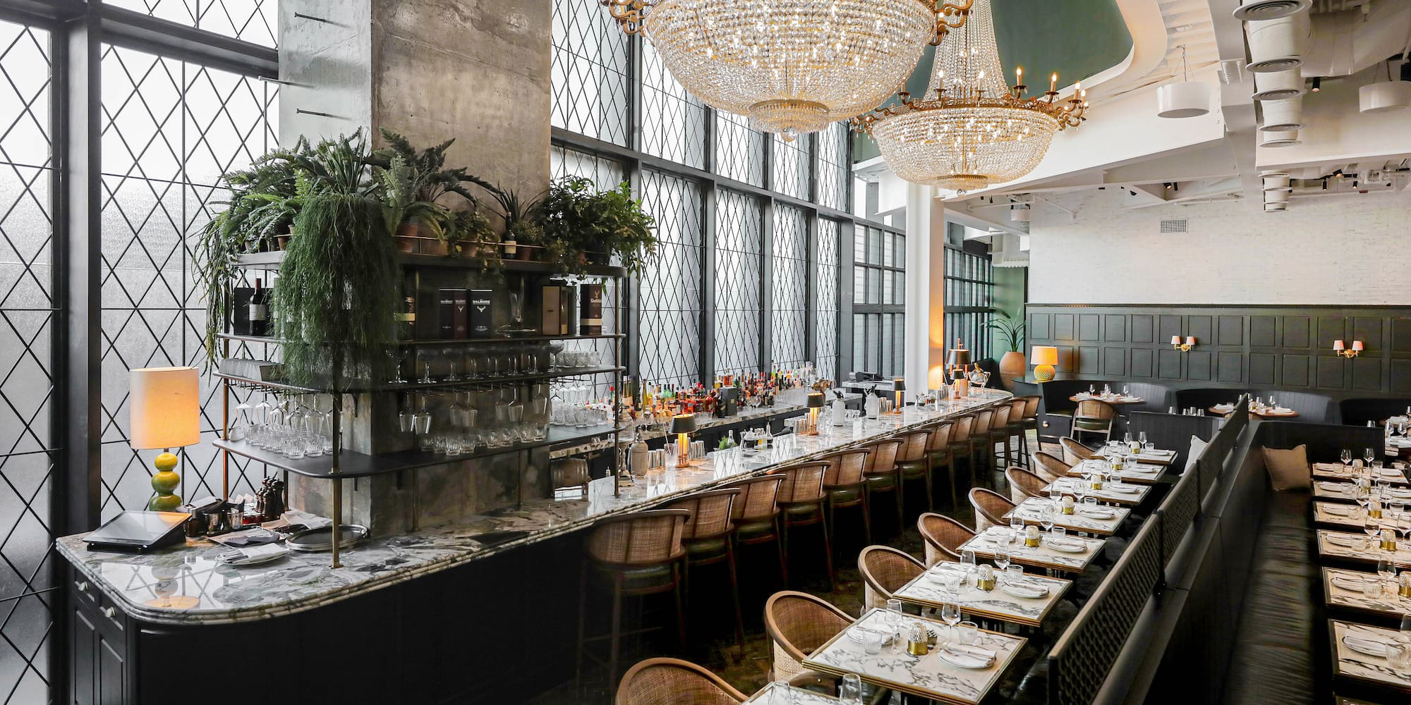 a long table with chairs and chandeliers