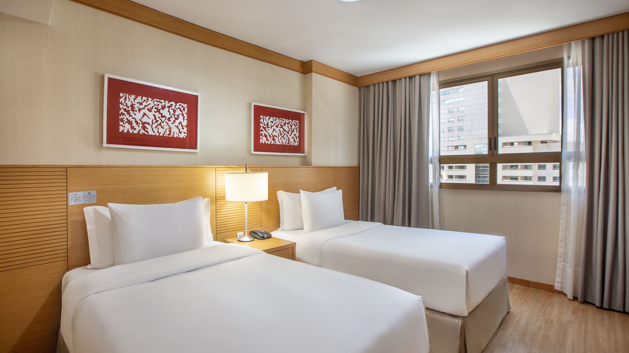 a room with two beds and a lamp