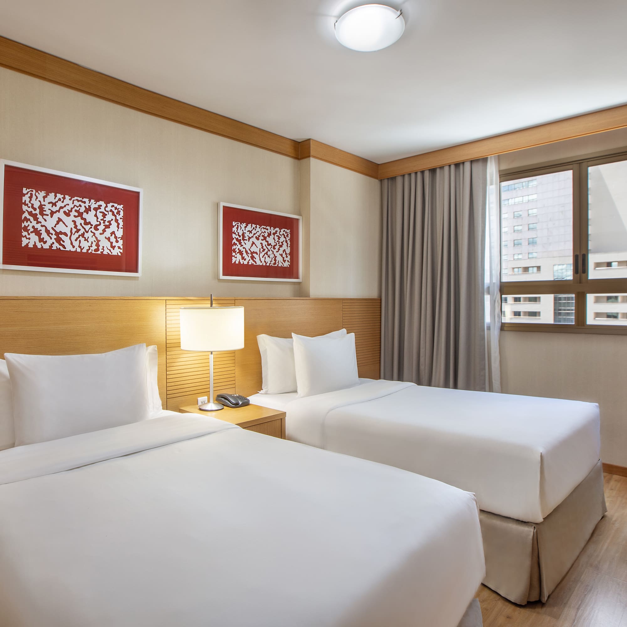 a room with two beds and a lamp