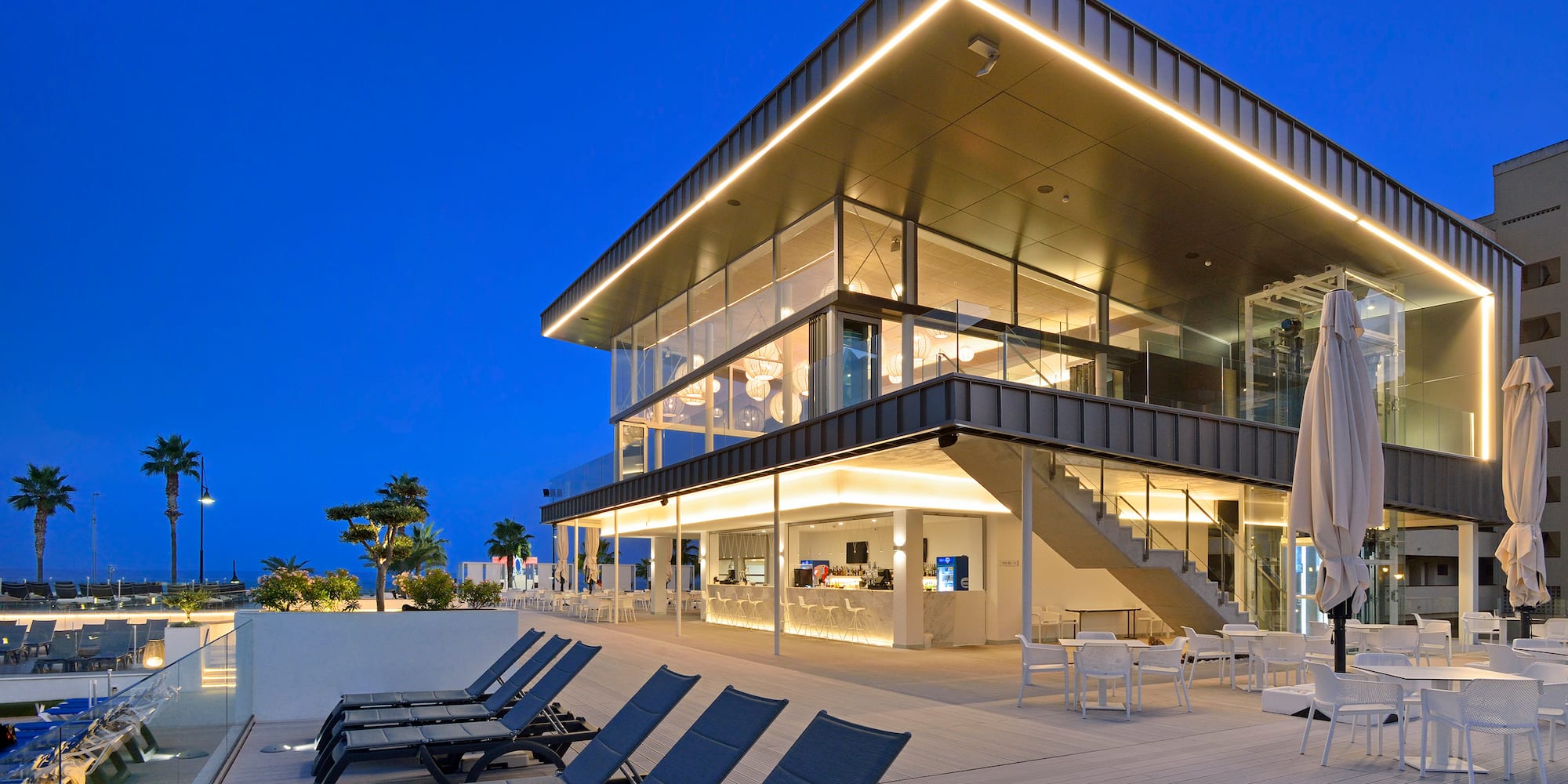 a building with chairs and a pool