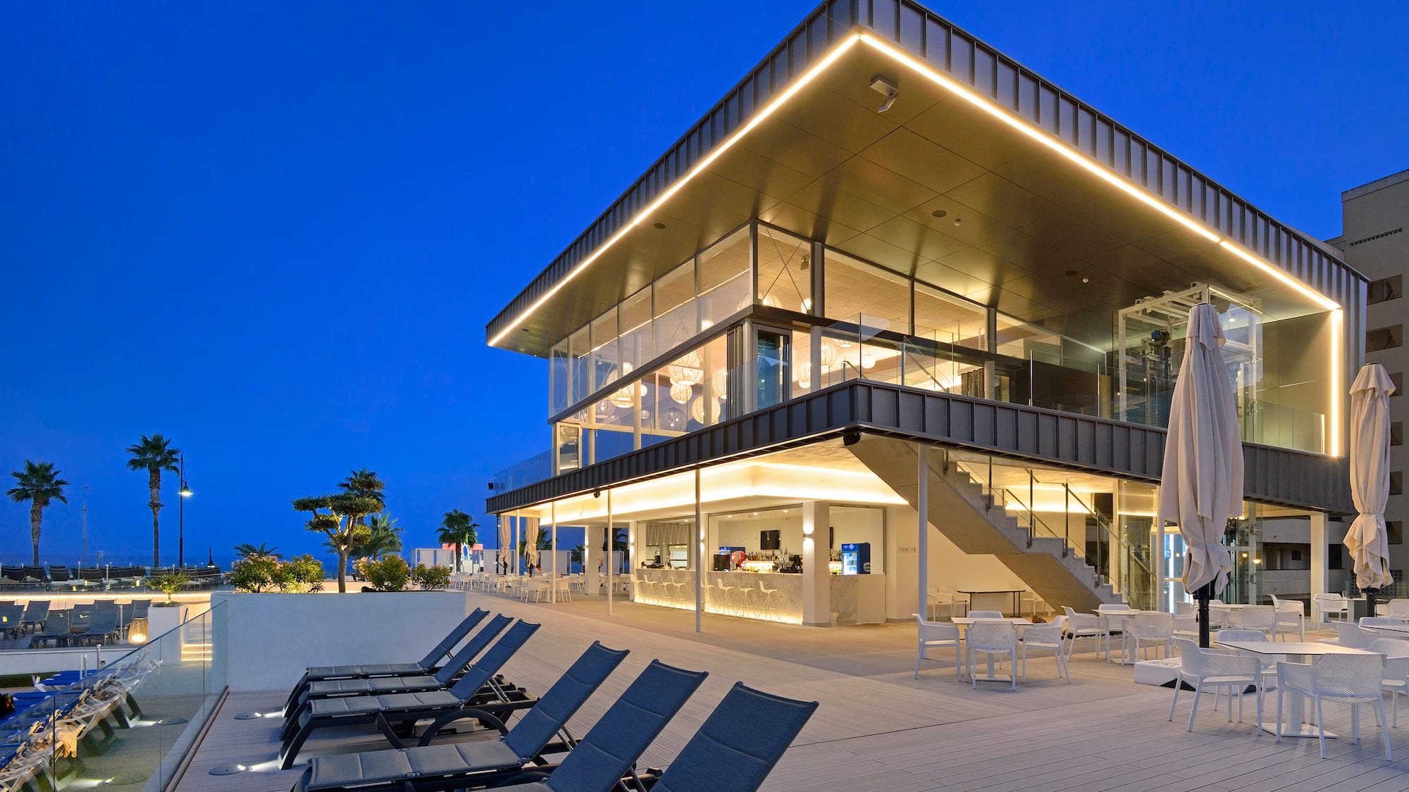 a building with chairs and a pool